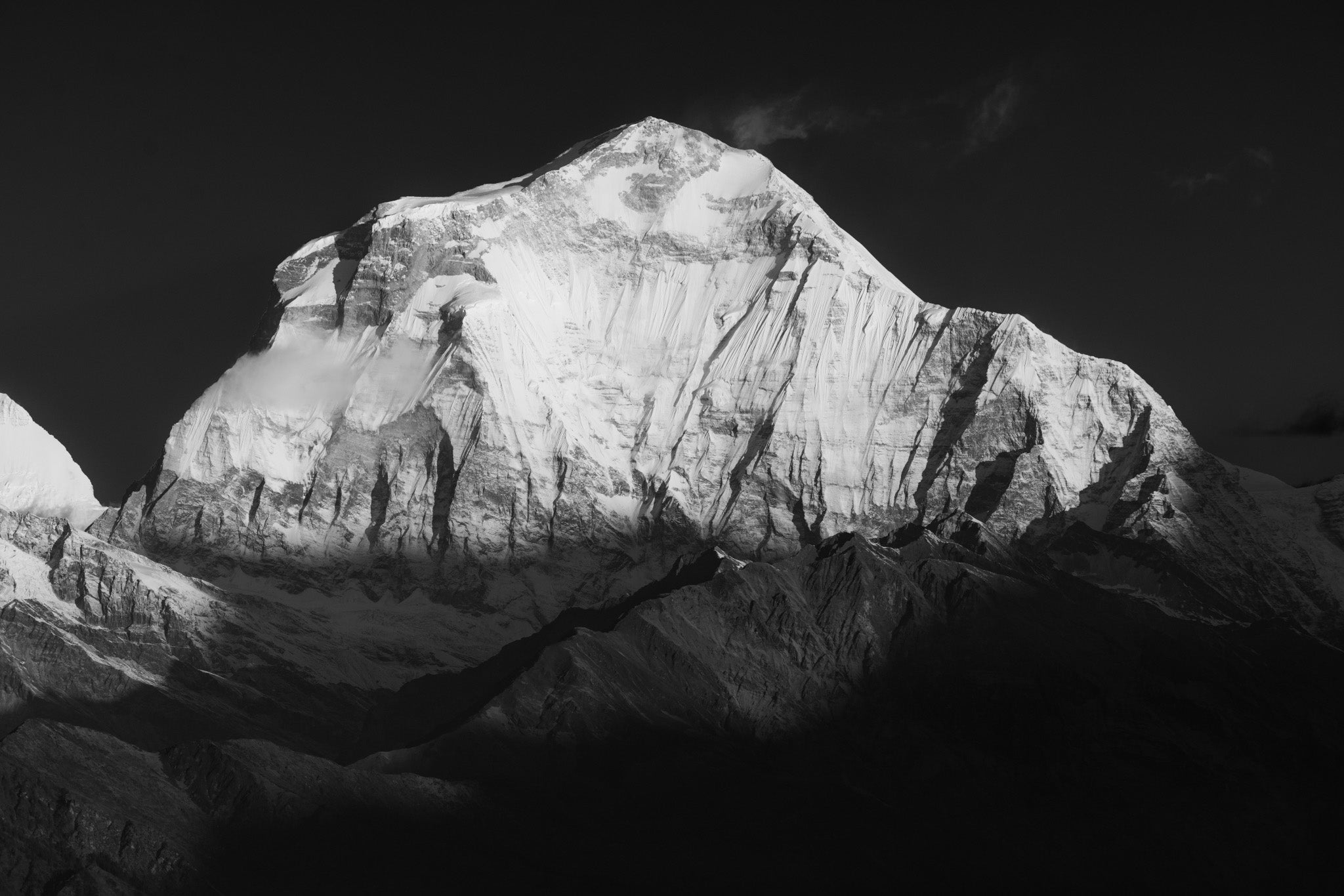A black and white mountain landscape print of Dhaulagiri I, the 7th highest mountain in the world.