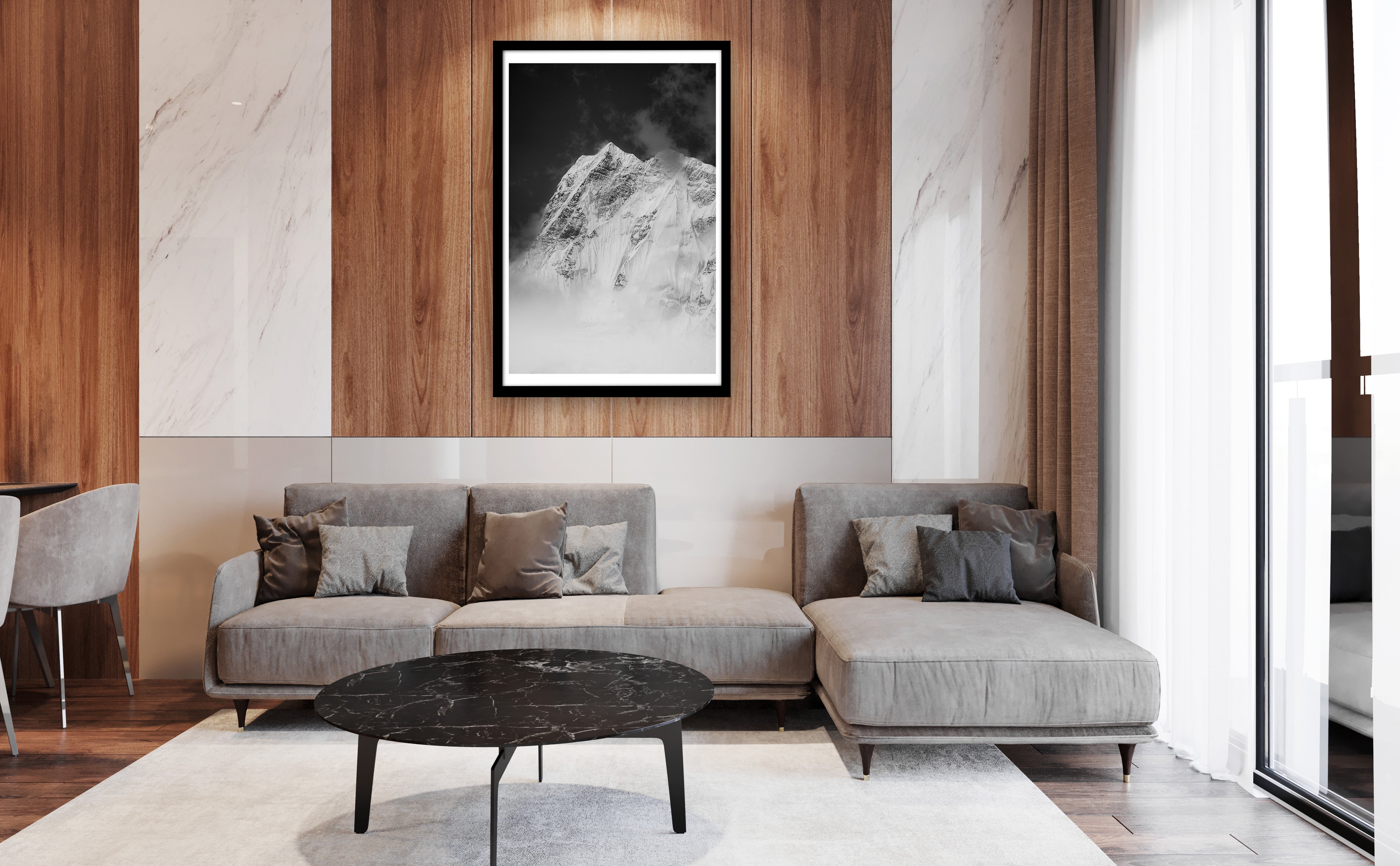 Modern living room with gray sofa, round coffee table, and mountain artwork on wall.